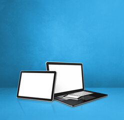 Laptop, mobile phone and digital tablet pc on blue office desk