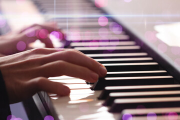 close up of a hand playing the piano