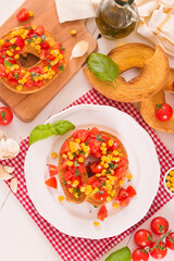 Friselle with tomatoes and mais.