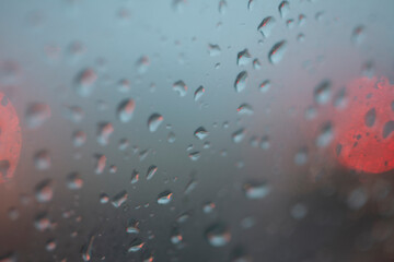 blurry blue background with raindrops and red lights