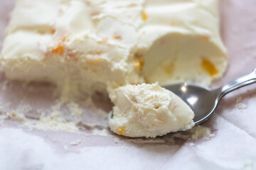 cottage cheese with dried apricots on a teaspoon close-up