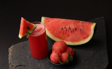 Watermelon smoothies or juice topping with fresh watermelon and mint leaves for summer drinks concept.