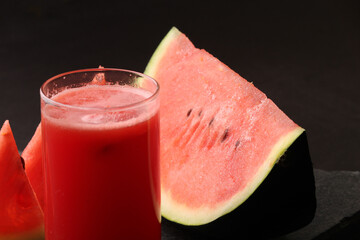 Watermelon smoothies or juice topping with fresh watermelon and mint leaves for summer drinks concept.