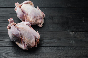 Fresh raw chicken, on black wooden table with copy space for text