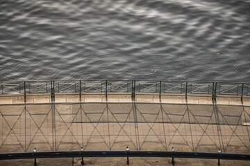 Fototapeta premium Empty embankment by Moldau river in Prague with handrail and sidewalk