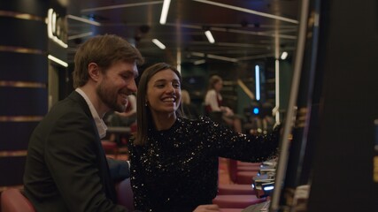 Young couple playing slot machine