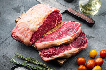 Striploin steak, raw beef butchery cut, on gray background