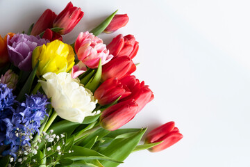 A bouquet of flowers laid out on a light background. Bouquet for March 8, Mother's Day, Teacher's Day.