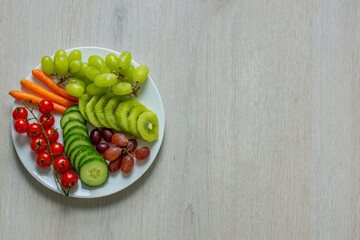 plate with fruits and vegetables copy space for text