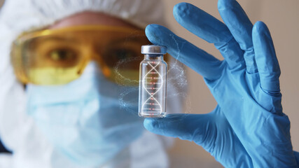 Young woman in eyeglasses and protective mask with gloves holding test tube with 3d model of human DNA. Health care concept. Infecting process. Female doctor scientist searching for medical innovation