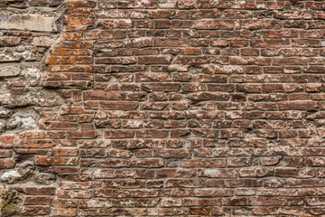 Naklejka premium Old&nbsp;grungy&nbsp;retro&nbsp;dirty&nbsp;dusty&nbsp;brick&nbsp;wall&nbsp;of&nbsp;ancient&nbsp;city.&nbsp;Uneven&nbsp;pitted&nbsp;peeled&nbsp;surface&nbsp;brickwork&nbsp;of&nbsp;cellar&nbsp;worn.&nbsp;Ruined&nbsp;shabby&nbsp;stiff&nbsp;blocks.&nbsp;Hard&nbsp;solid&nbsp;messy&nbsp;ragged&nbsp;holes&nbsp;brickwall&nbsp;for&nbsp;3D&nbsp;grunge&nbsp;design
