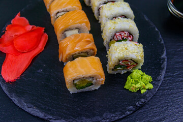 Set of sushi rolls on a black stone slate