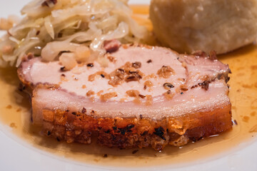 Slice of Austrian Roast Pork called Schweinsbraten with Coleslaw and Potato Dumpling