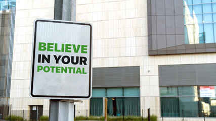 Believe in your potential sign in a downtown city setting