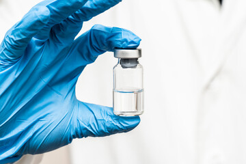 Doctor holding medicine for vaccination, closeup