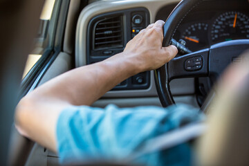 Driver's hands on the steering wheel
