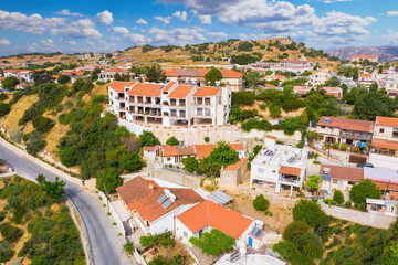 Fototapeta na wymiar Cyprus Pissouri village. Small village on island of Cyprus. Apartments and houses in Pissouri resort. Panorama of Pissouri from a drone. Highway near the Cypriot village. Mediterranean city
