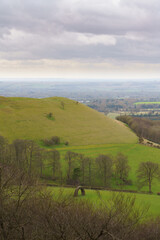 scenic Southerly view over Oare and across the Pewsey Vale valley with green pastures and a cloudy light grey sky