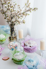 Beautiful Easter cakes on a decorated light table. A light holiday of Easter.