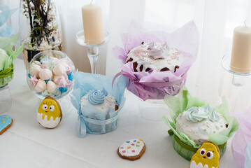 Fototapeta na wymiar Beautiful Easter cakes on a decorated light table. A light holiday of Easter.