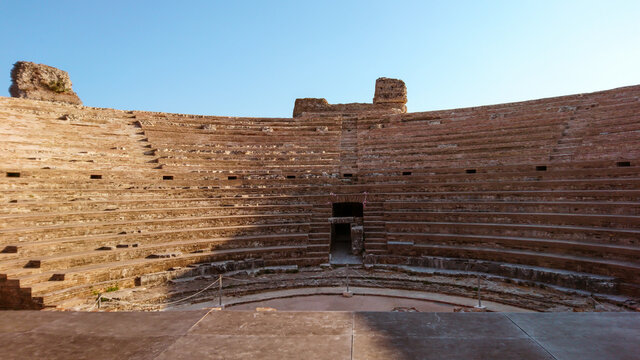 Roman Odeum Of Nicopolis ancient cultural landmark in Greece. Marble historical theater construction, view from stage to audience seats. Travel Europe