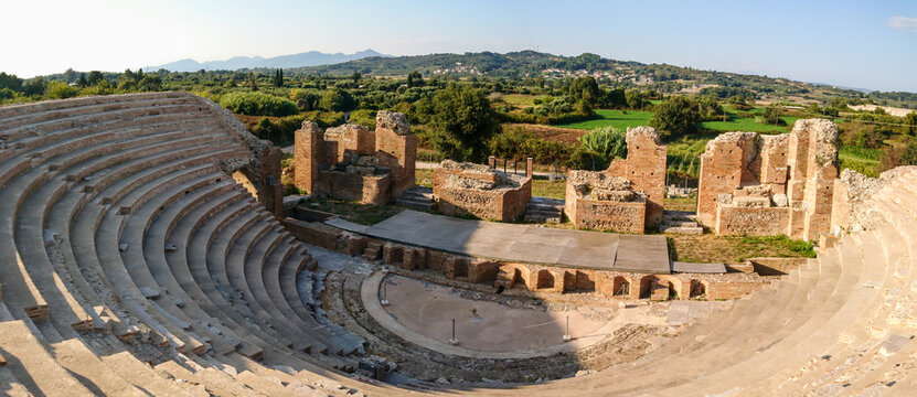 Roman Odeum Of Nicopolis ancient cultural landmark in Greece wide panorama. Marble historical theater construction, panoramic view on stage in center. Travel Europe