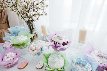 Beautiful Easter cakes on a decorated light table. A light holiday of Easter.