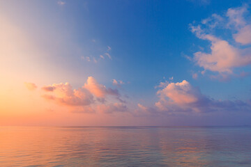 Fototapeta premium Sea ocean horizon. Skyscape with seascape. Orange and golden sunset sky, soft sand, calmness, tranquil relaxing sunlight, summer mood. Inspirational nature view, wide horizon of the sky and the sea