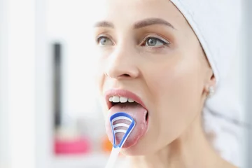 Deurstickers Woman cleans her tongue with special scraper © megaflopp