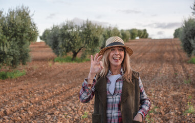 Happy female field engineer examining in agricultural plantation. Integration of women in the field, agriculture and happy women concepts