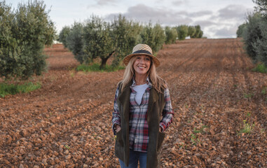 Happy female field engineer examining in agricultural plantation. Integration of women in the field, agriculture and happy women concepts