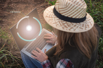 Fototapeta premium Female field engineer using computer in agricultural plantation. Integration of women in the field, agriculture and happy women concepts