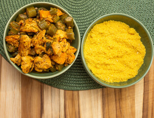 top view of delicious brazilian meal with bowls full of  piece of chicken and 