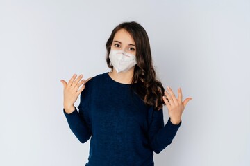 beautiful young woman wearing an anti viurs protection ffp2-mask to prevent from corona covid-19 and sars cov 2 infection white background copy space