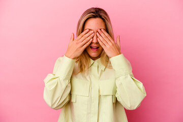 Young mixed race woman isolated on pink background afraid covering eyes with hands.