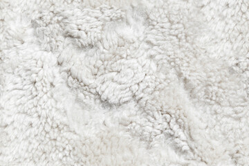Natural white sheepskin, seamless background texture
