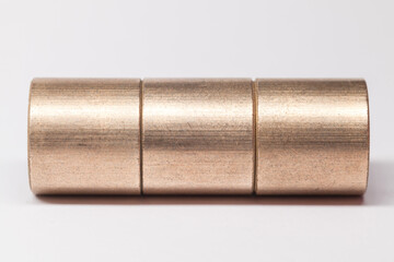 Sleeve bronze bearings in a row on white background