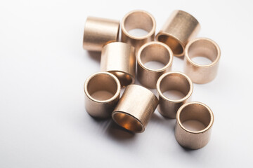 Group of sleeve bronze bearings is on a white background