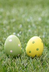 Happy Easter. Pastel colored eggs on green grass, close up view