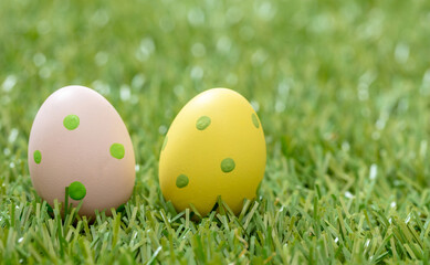 Happy Easter. Pastel colored eggs on green grass, close up view