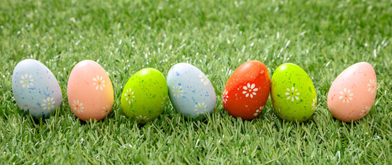 Fototapeta na wymiar Happy Easter. Colorful eggs on green grass, close up view