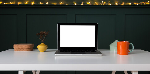 Laptop with blank screen on a table.	