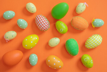 Obraz na płótnie Canvas Happy Easter. Pastel orange and green color eggs on orange background