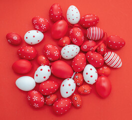Happy Easter. Red and white color eggs on red background, top view