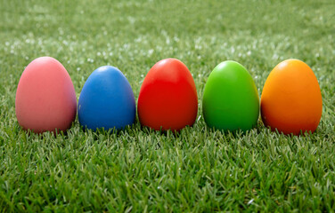 Fototapeta na wymiar Happy Easter. Colorful eggs on green grass, close up view