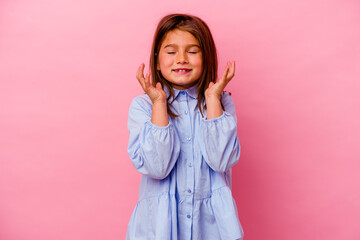 Little caucasian girl isolated on pink background  joyful laughing a lot. Happiness concept.