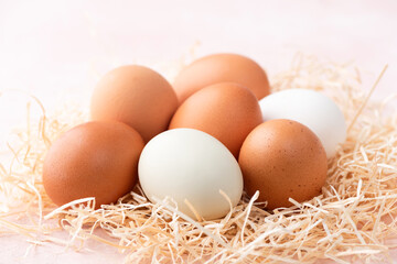 Chicken eggs on pink background closeup view. Easter eggs