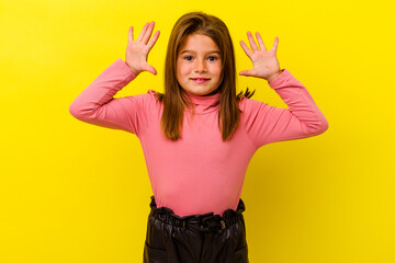 Little caucasian girl isolated on yellow background receiving a pleasant surprise, excited and...