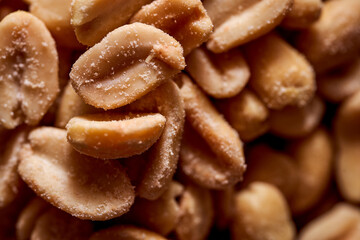 Salted peanuts on a wooden background. With copy space.Macro effect photo.