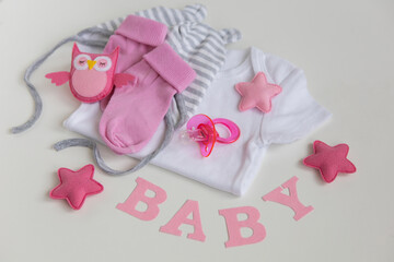 infant baby clothes baby girl pacifier cap on background